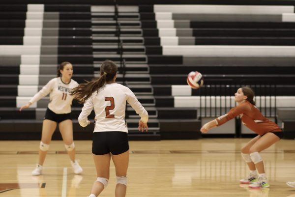 Anticipating fellow teammate Defensive Specialist Claire Toupin '27's upward launch of the ball, Outside Hitter Leticia Viana '26 prepares to retaliate against the opposing team. The team utilized fluid teamwork and consistent aggression to eventually win the game. 